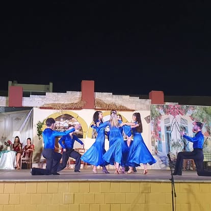 Stage dance performance with blue costumes